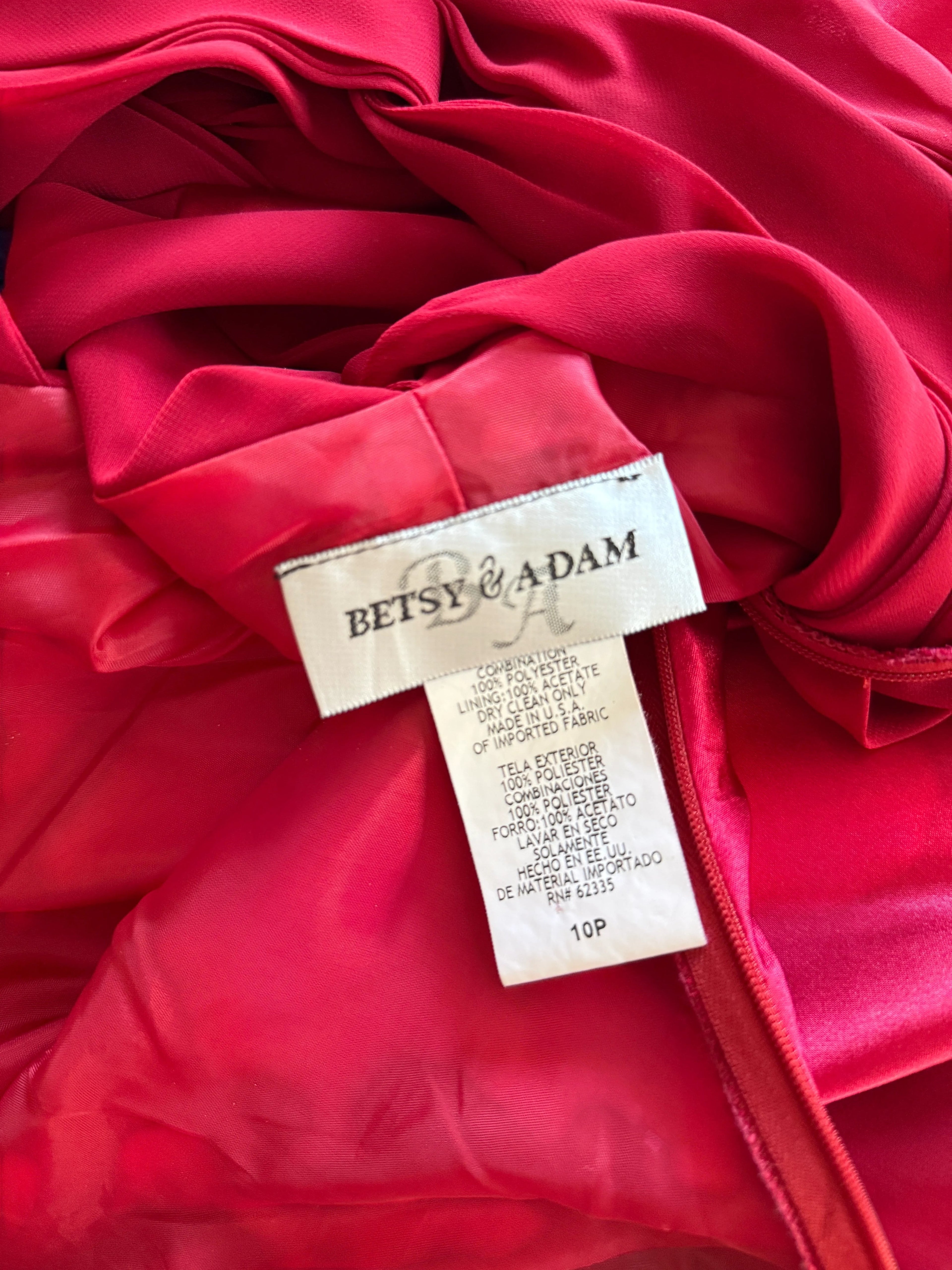 Orvaniwear Betsy & Adam red satin gown interior label showing size 10P and fabric care instructions