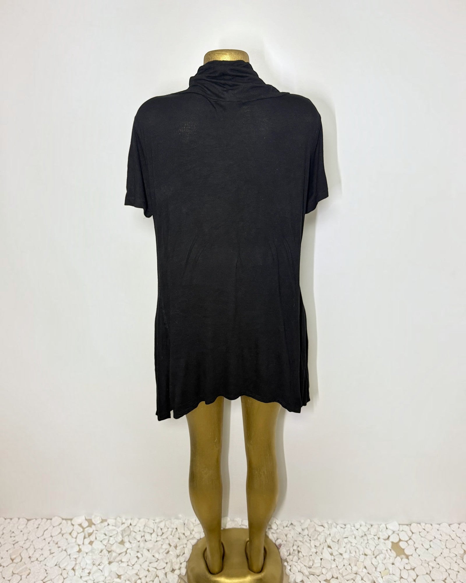 Orvaniwear black short-sleeve tunic with a draped cowl neckline and asymmetric handkerchief hem on a mannequin.