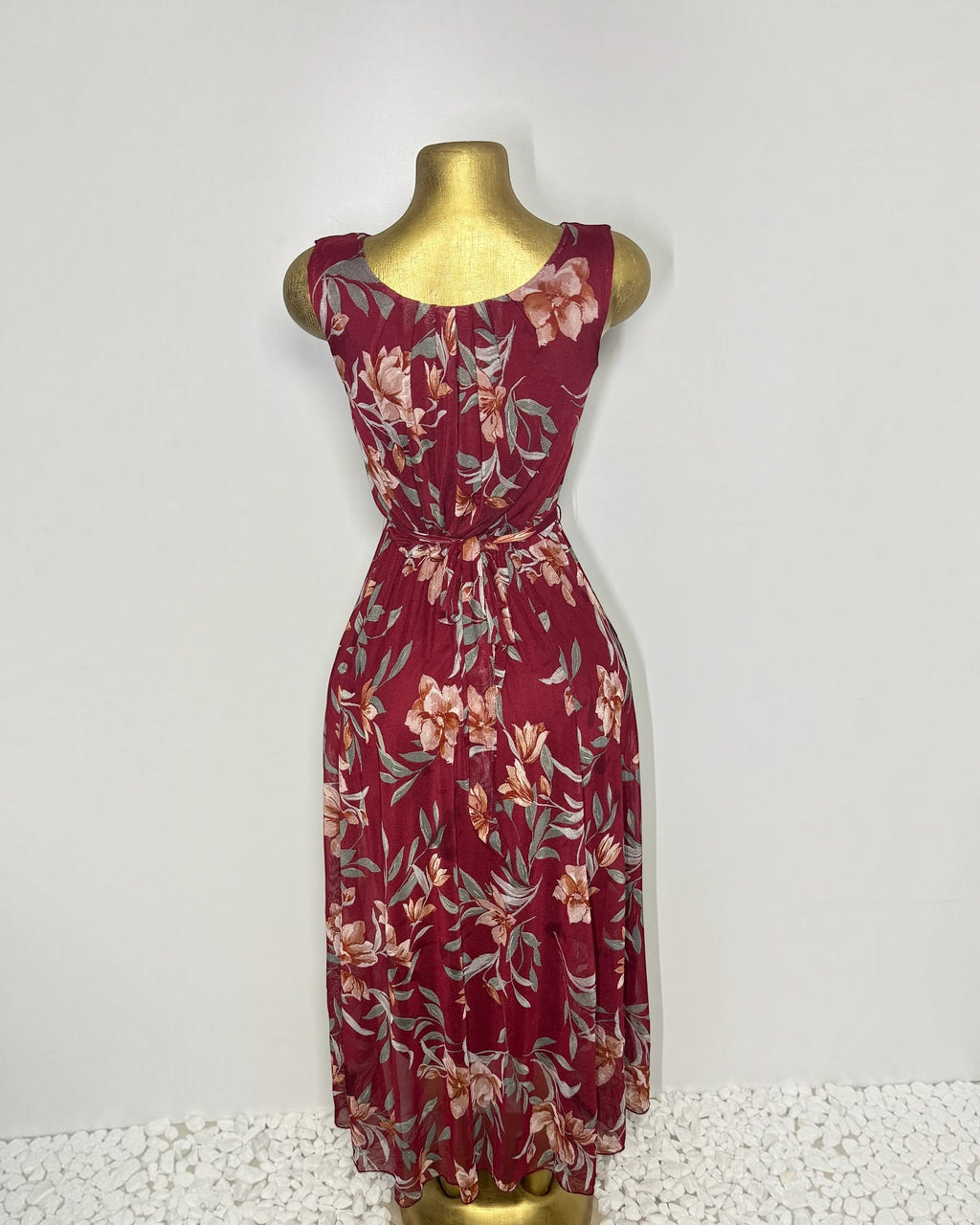 Orvaniwear burgundy floral mesh midi dress with a sleeveless boat neckline, tie waist, and pleated skirt back view.