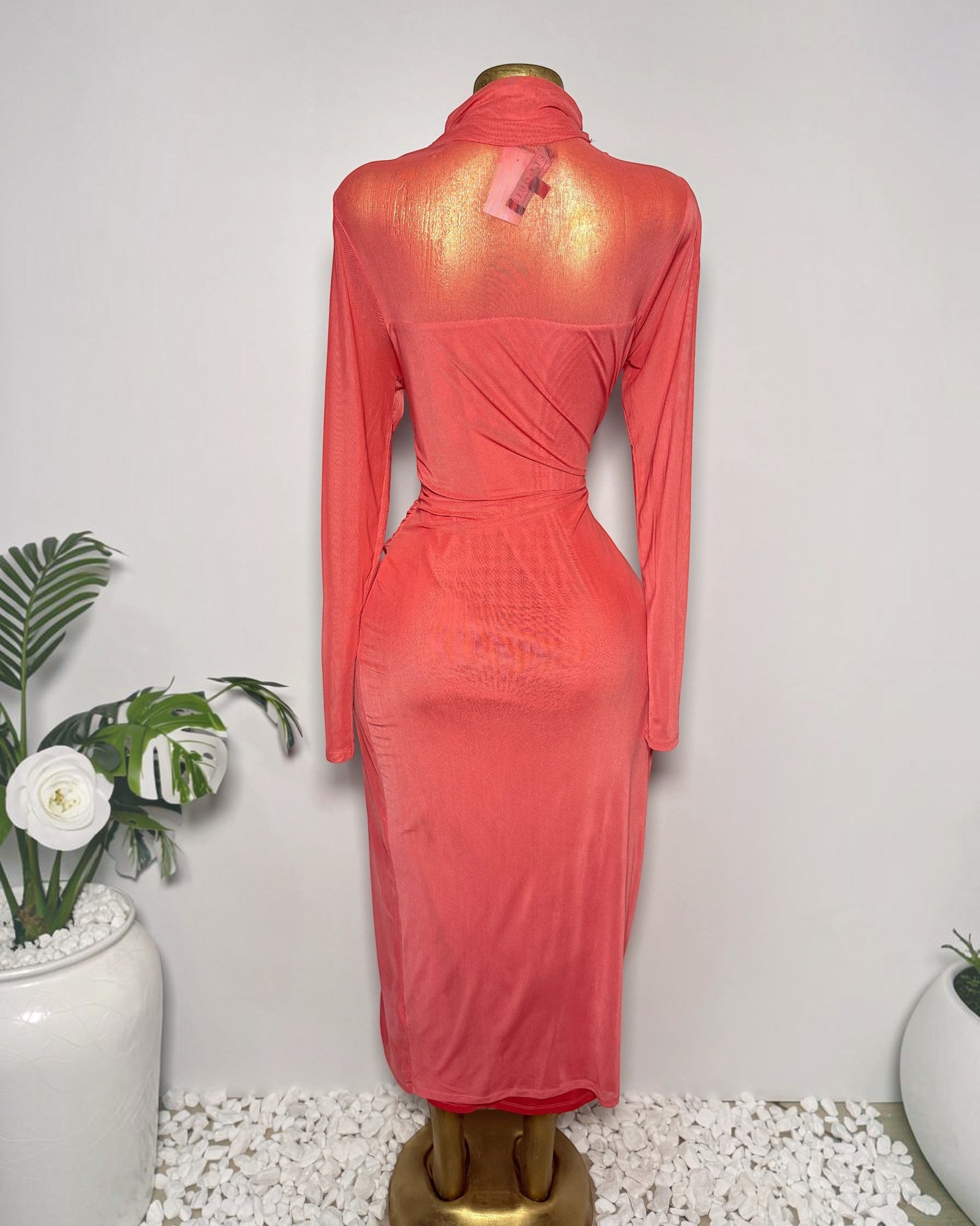 Back view of Orvaniwear coral mesh midi dress with long sleeves, halter neck, and ruched tie waist on a mannequin.