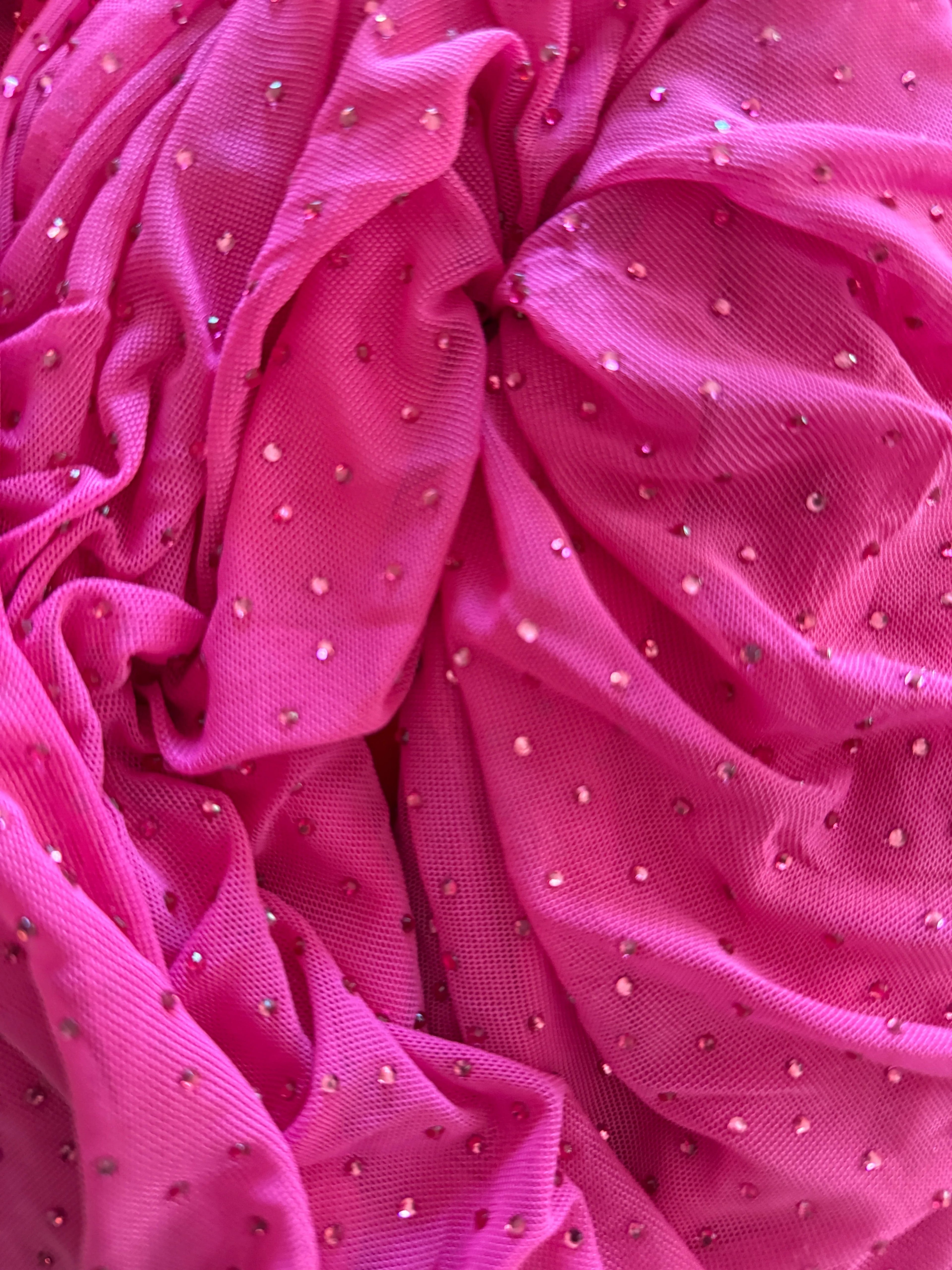 Orvaniwear hot pink mesh bodycon dress featuring scattered rhinestone embellishments and ruched fabric texture.