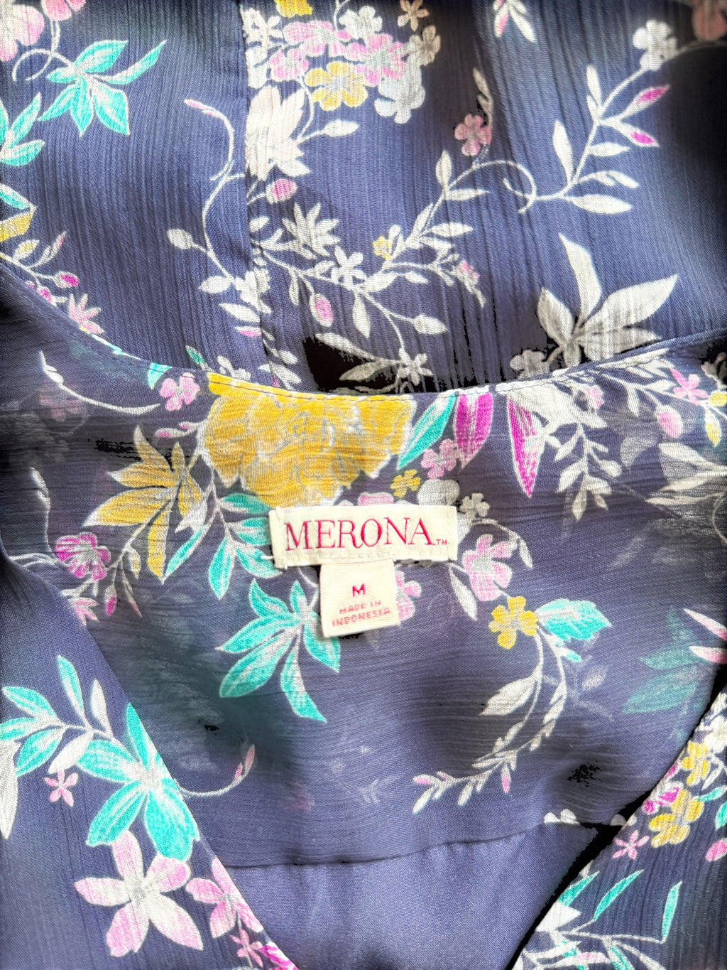 Orvaniwear Merona navy midi dress featuring a colorful pink, yellow, and green floral print with a V-neckline.
