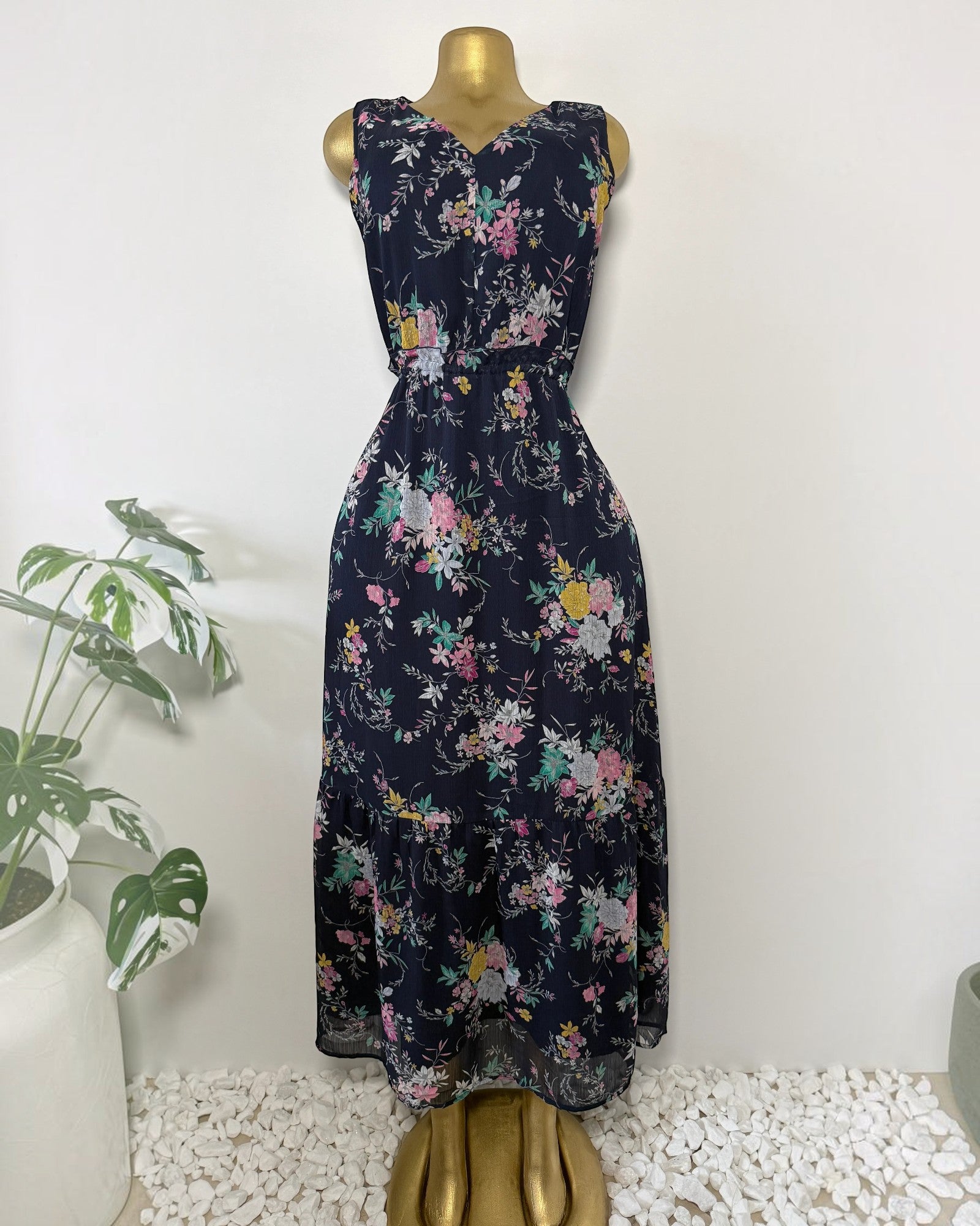 Orvaniwear navy midi dress with pink, yellow, and green floral print, sleeveless V-neck, and tiered ruffle hem.