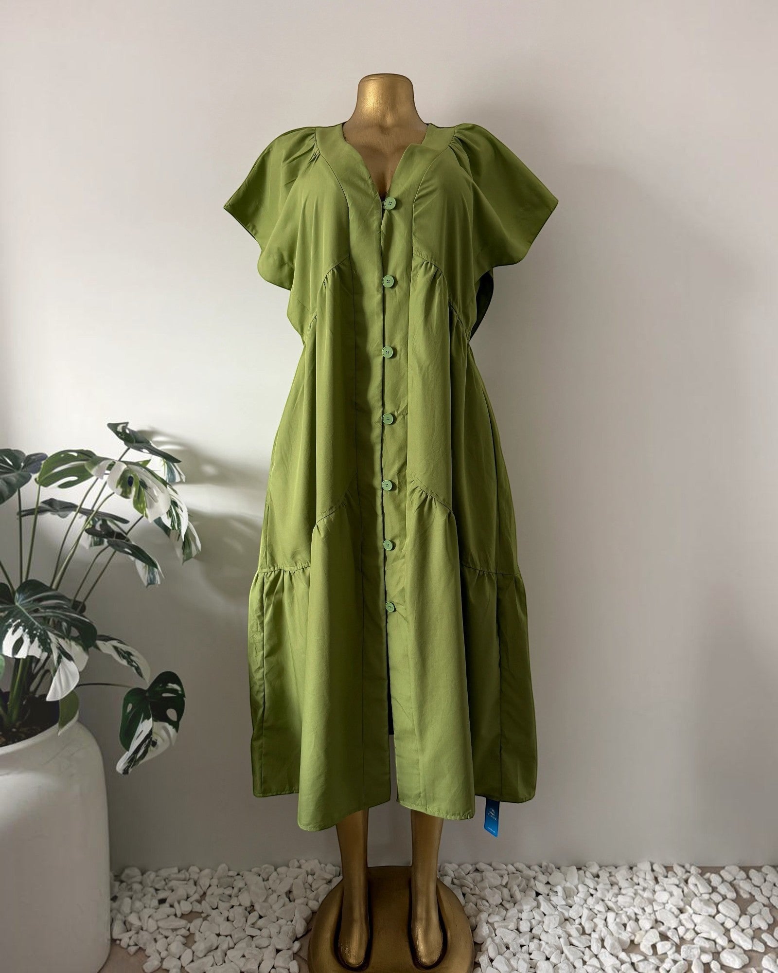 Orvaniwear olive green midi dress with V-neck, cap sleeves, button-front, and tiered skirt on a mannequin.