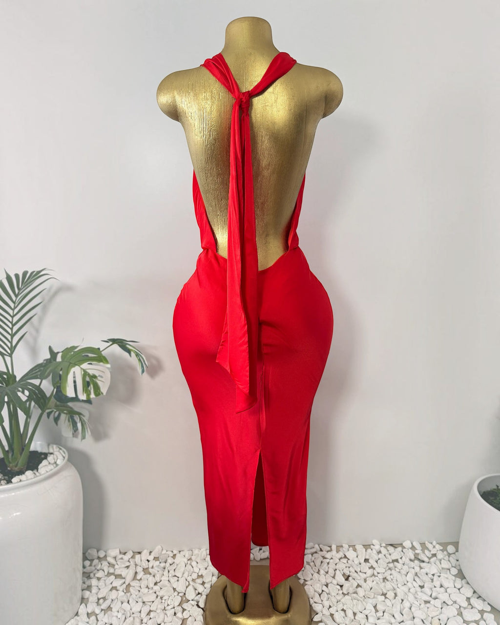 Orvaniwear red maxi dress featuring a halter neckline, dramatic open back with tie closure, and bodycon silhouette.