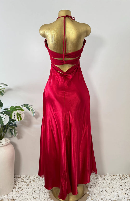 Orvaniwear red satin halter gown with strappy open back detail on a mannequin