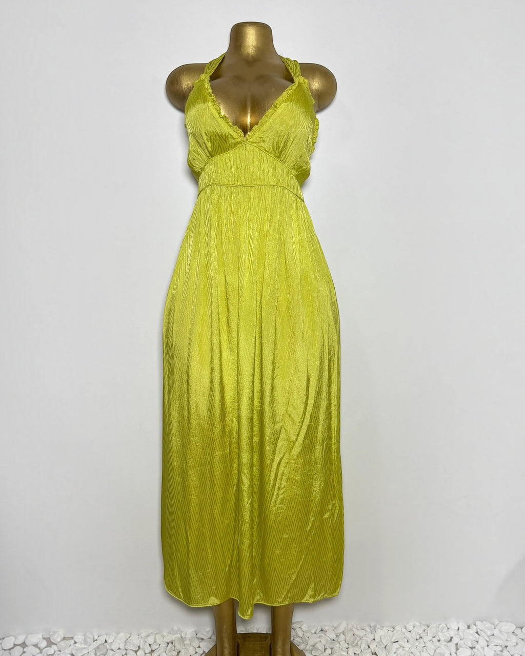 Orvaniwear Zara lime green satin midi dress with a plunging halter neckline and textured chevron pattern.