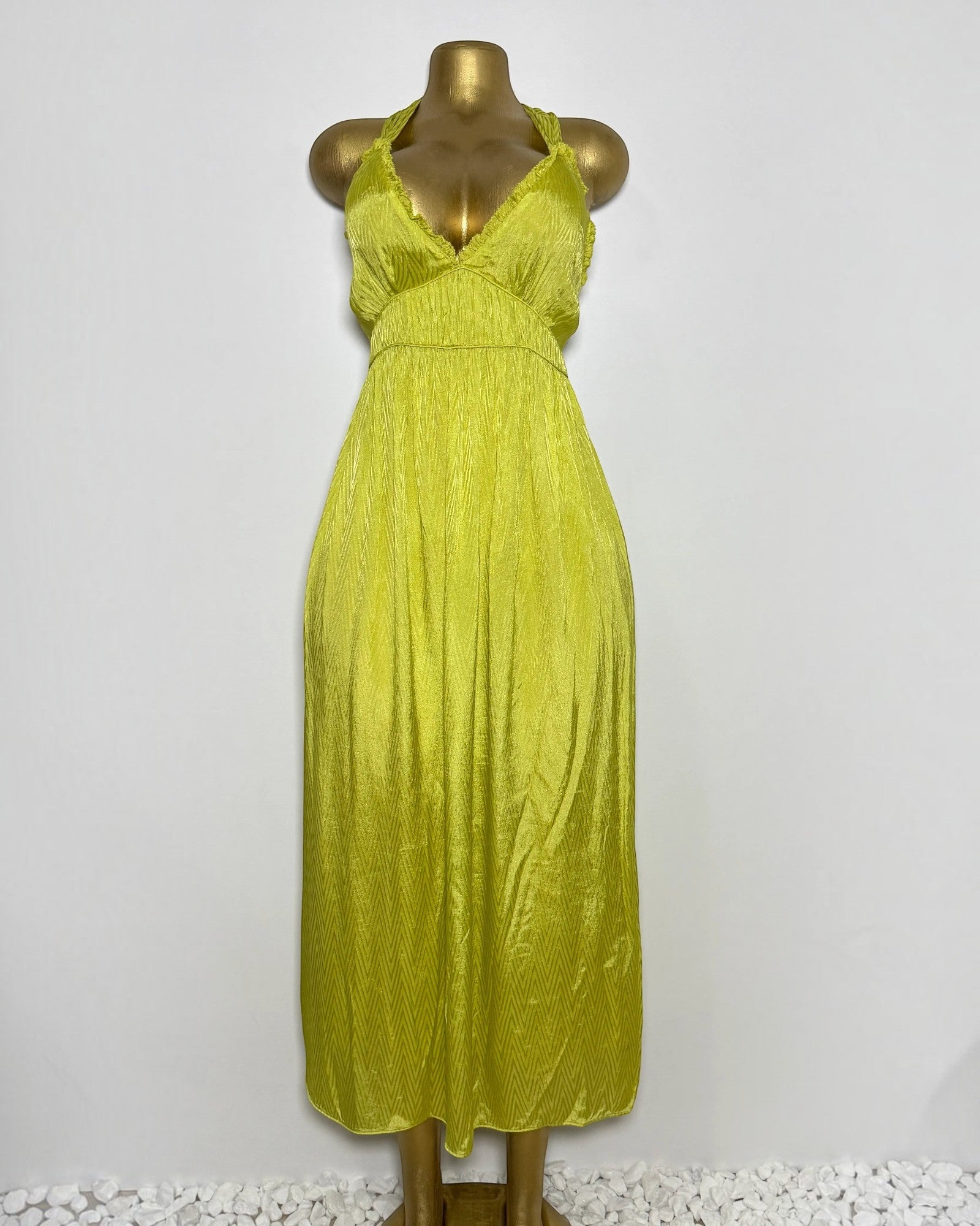 Orvaniwear Zara lime green satin midi dress with a plunging halter neckline and textured chevron pattern.